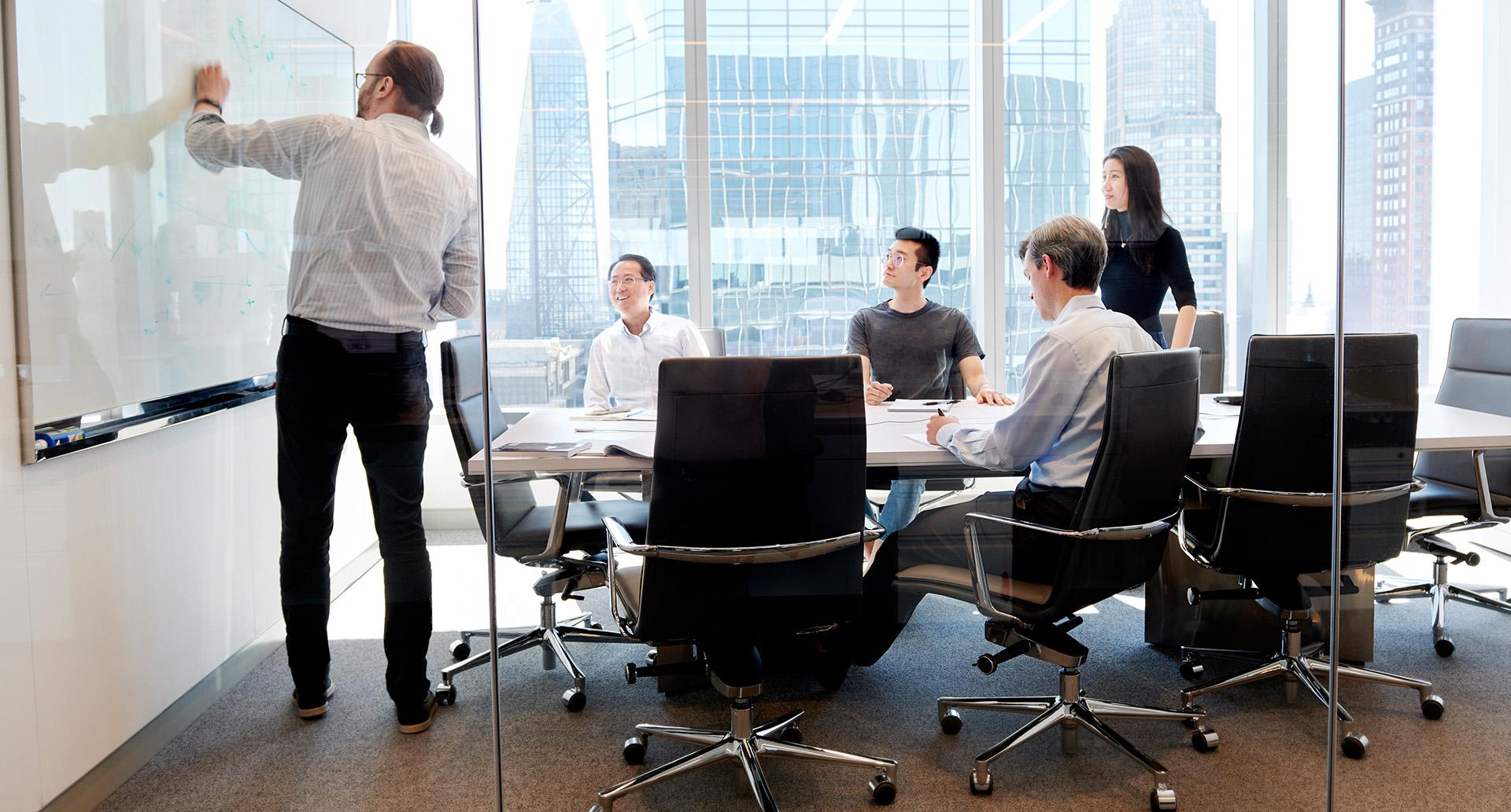 Employees having a meeting in an office room