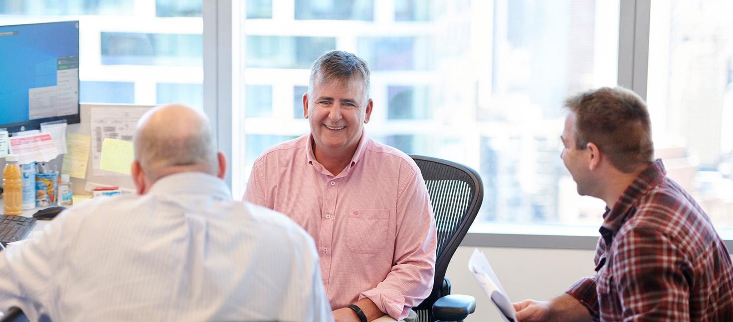 Employees casually talking to each other in the office