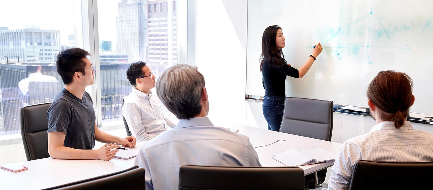 Employees having a meeting in an office room